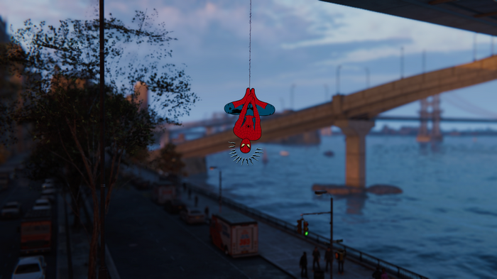 Spider-Man hanging upside down over a river