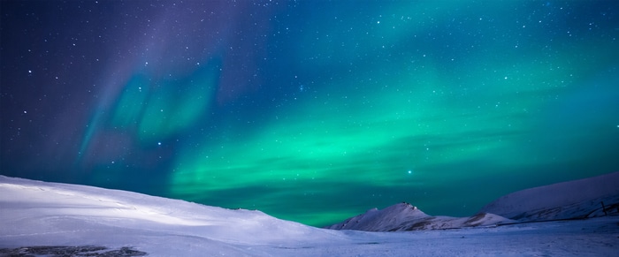 4K Aurora Borealis over snowy landscape