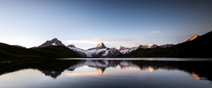 4K reflection of mountains in a lake at sunrise
