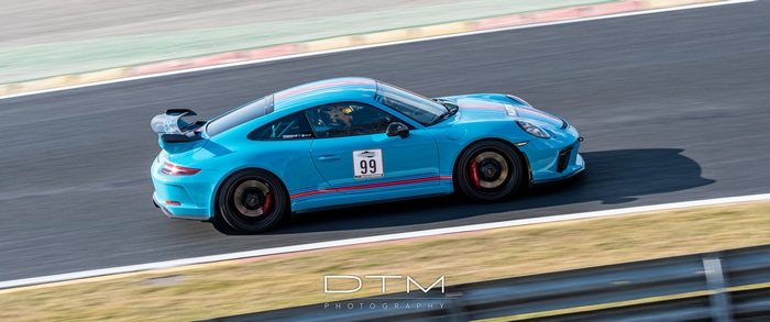 Blue Porsche 911 GT3 on a Race Track