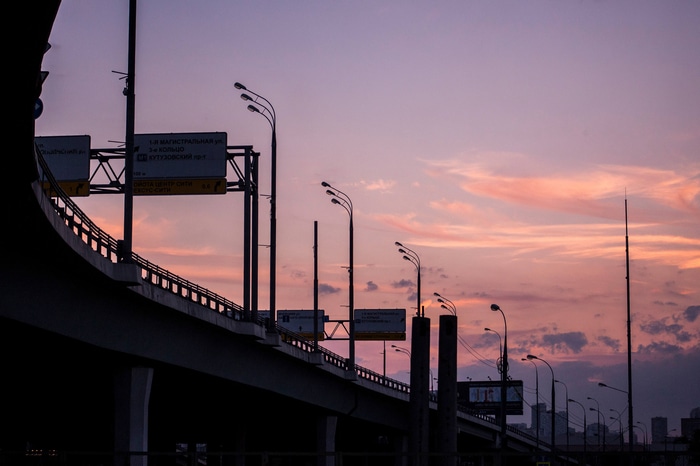 Road signs and streetlights at dusk