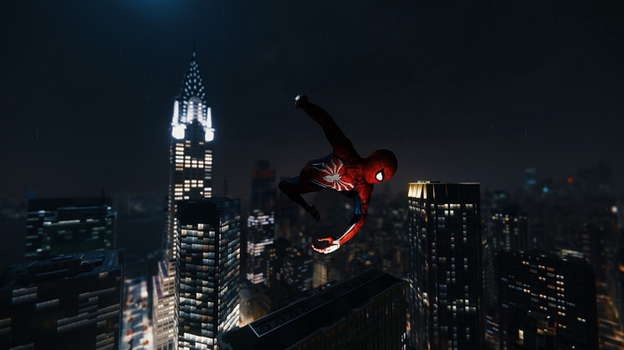 Spider-Man jumping over city buildings at night