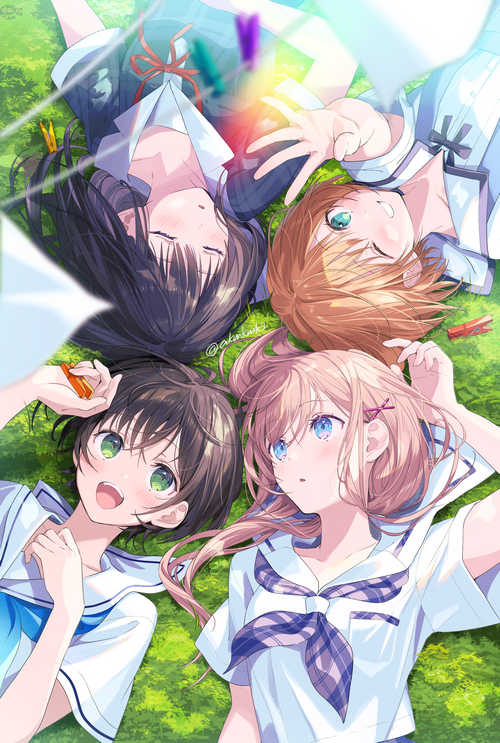 Four schoolgirls lying on grass with clothespins