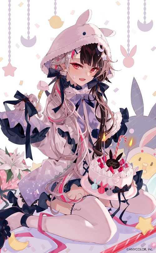 Girl with two-tone hair and bunny hood holding cake