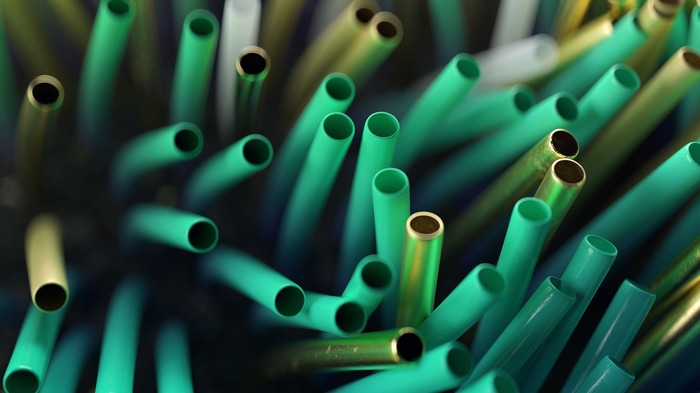 Abstract digital art of green and gold tubes