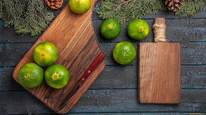 Still life of lemons and a knife on cutting boards
