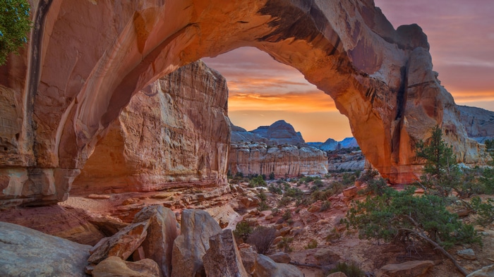 Natural rock arch at sunset in Capitol Reef National Park