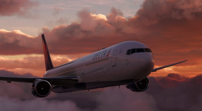 Delta airplane flying through clouds at sunset