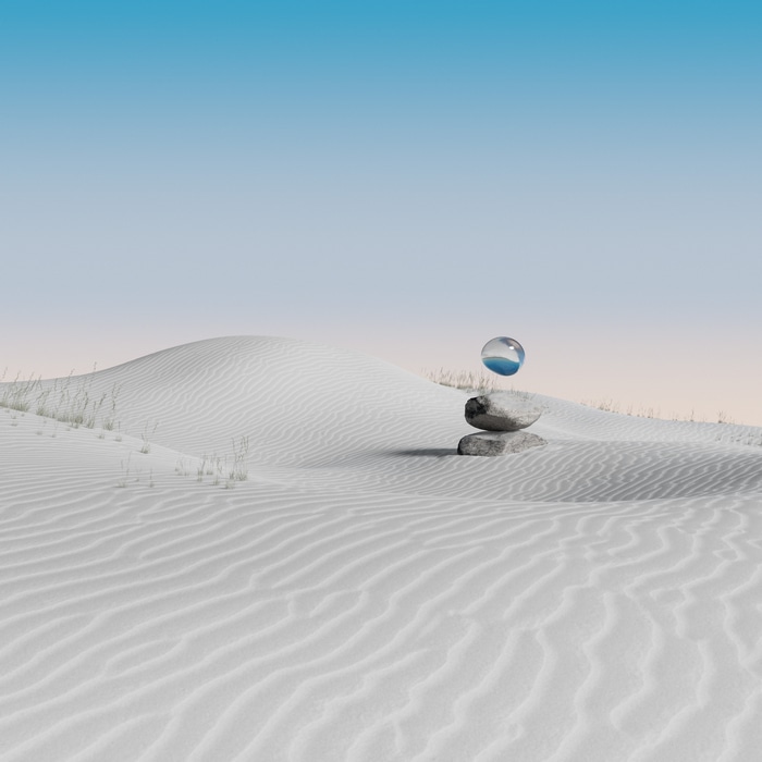 Desert landscape with balanced rocks and a glass orb