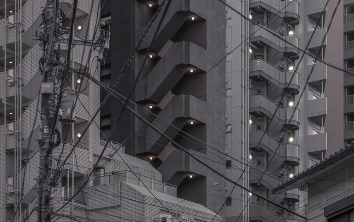 Cityscape with tangled wires and apartment buildings in Japan
