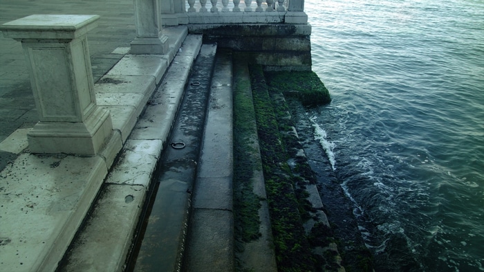 Stone stairs covered in moss leading to the sea