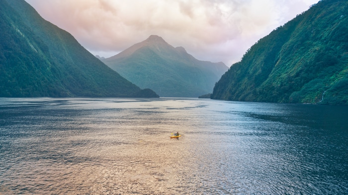 Kayaker in Milford Sound, New Zealand
