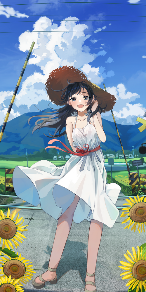 Girl in a straw hat with sunflowers at a train crossing