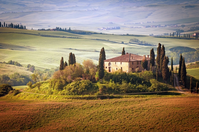 4K Italy landscape with a building and cypress trees
