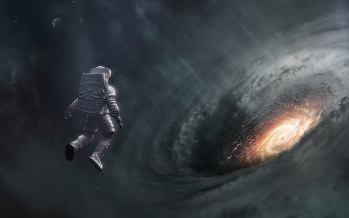 Astronaut floating near a swirling galaxy