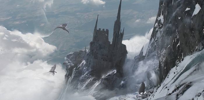 Fantasy castle on a snowy mountain with flying creatures