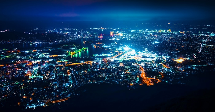 Aerial view of a city at night with bright lights