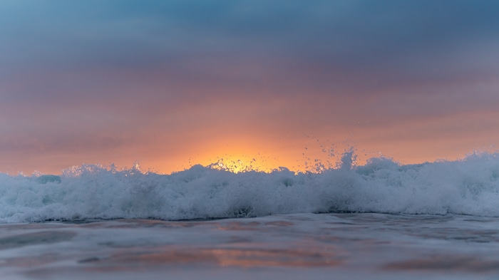 4K waves crashing at sunset