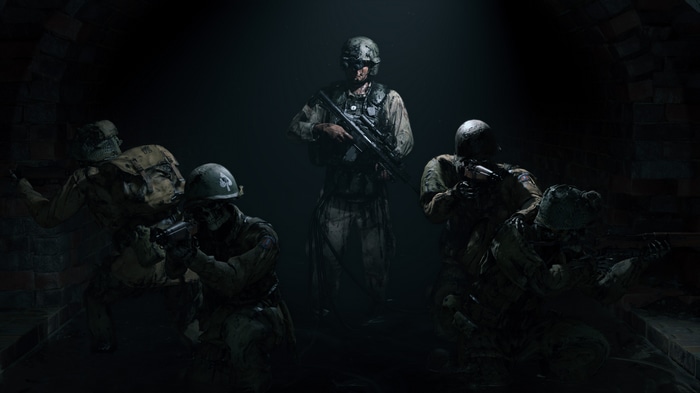 Soldiers in a dark, brick tunnel