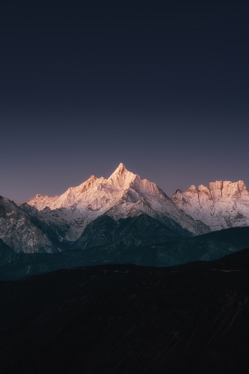 Snowy mountain peak at dusk