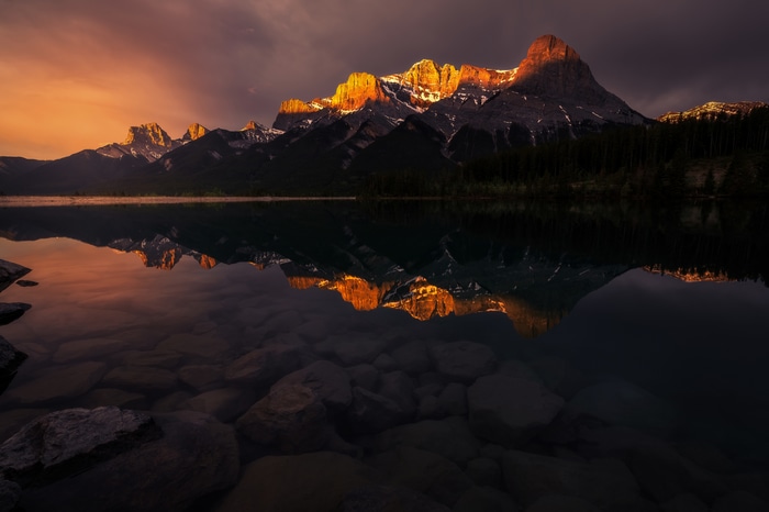 Sunset over the Rocky Mountains reflected in a lake