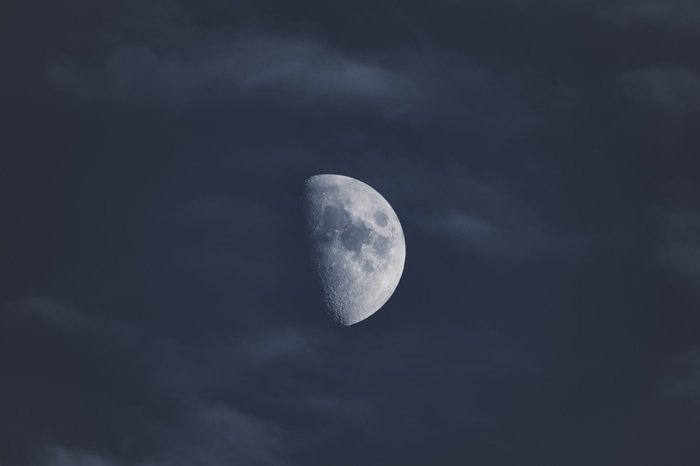 4K Moon in a cloudy blue sky