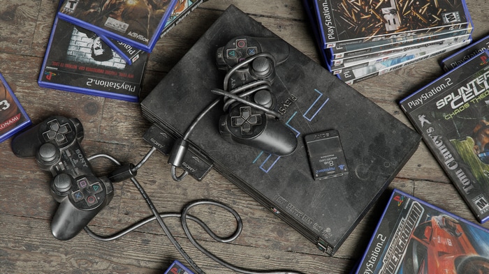 PlayStation 2 console with games and controllers
