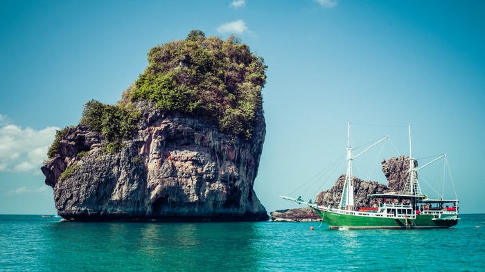 4K Thailand boat near rocky island