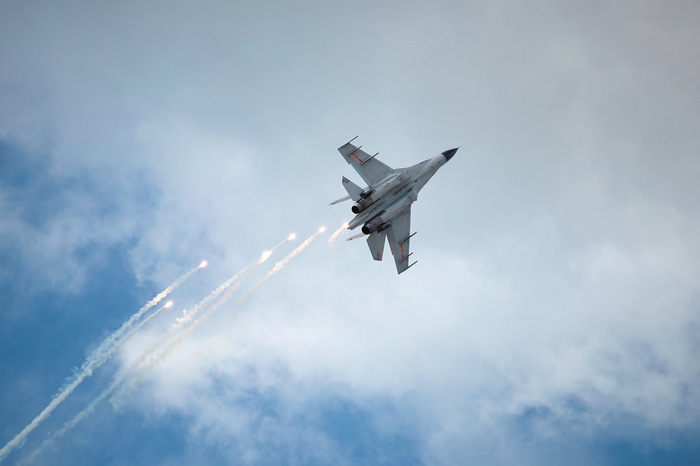 4K J-11 fighter jet releases flares in the sky