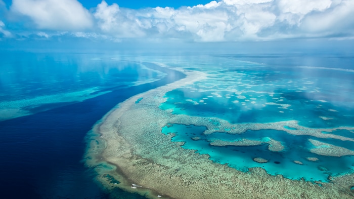 Aerial view of the Great Barrier Reef with clouds