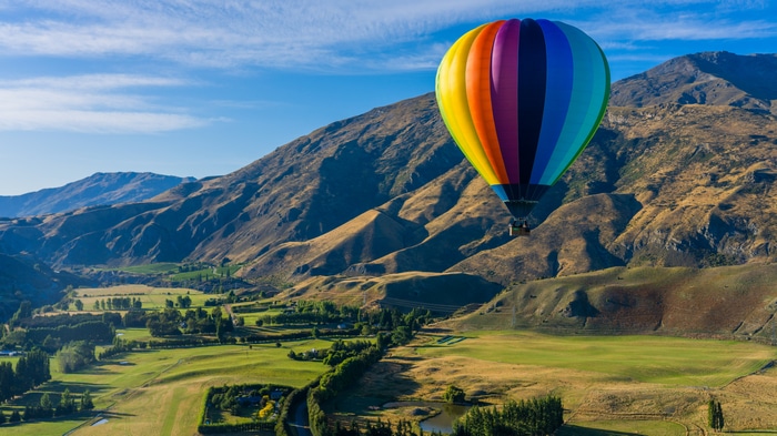 Hot air balloon over mountains in Queenstown, New Zealand