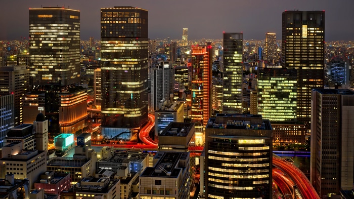 4K Osaka cityscape at night with illuminated skyscrapers