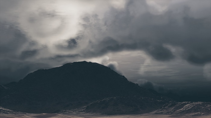 Assassin's Creed Origins: Mountainous landscape under cloudy sky