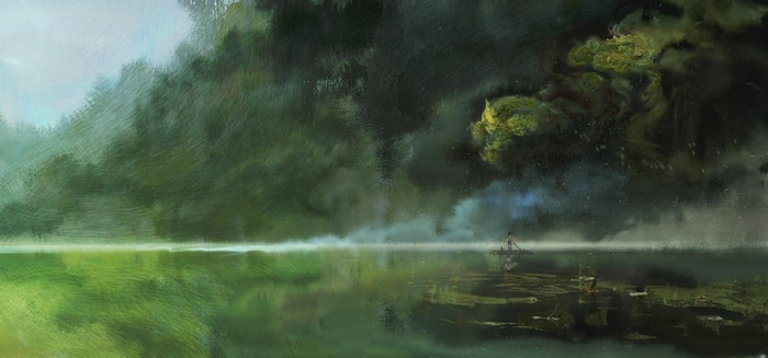 A person in a boat on a misty lake