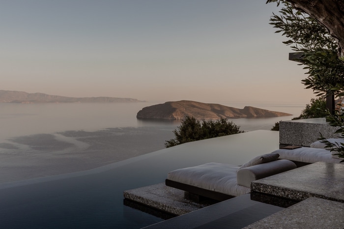Infinity pool overlooking islands at sunset