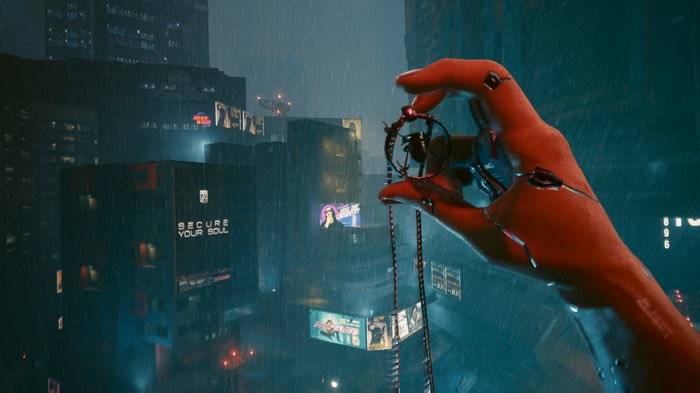 Cyberpunk 2077 hand holding a pendant in a rainy city