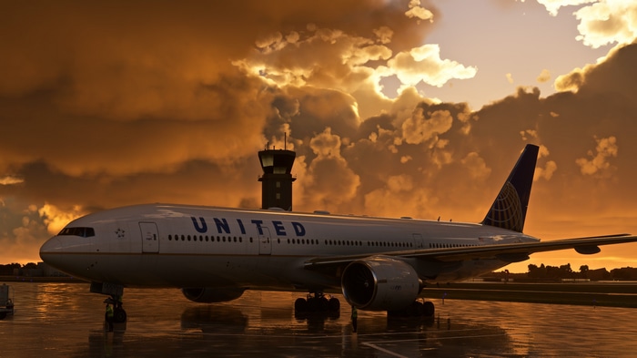 United Boeing 777 at airport during sunset with rain