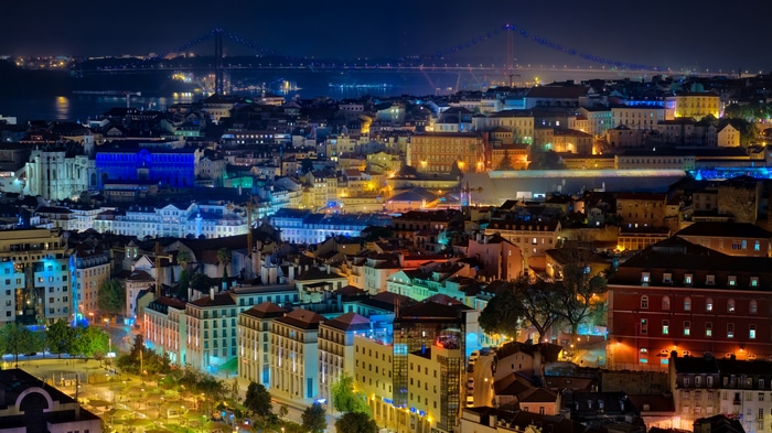 Lisbon cityscape at night with bridge