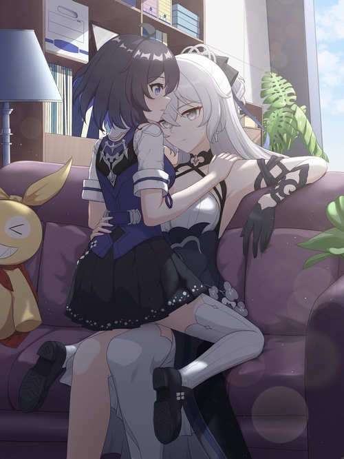 Two anime girls embracing on a couch