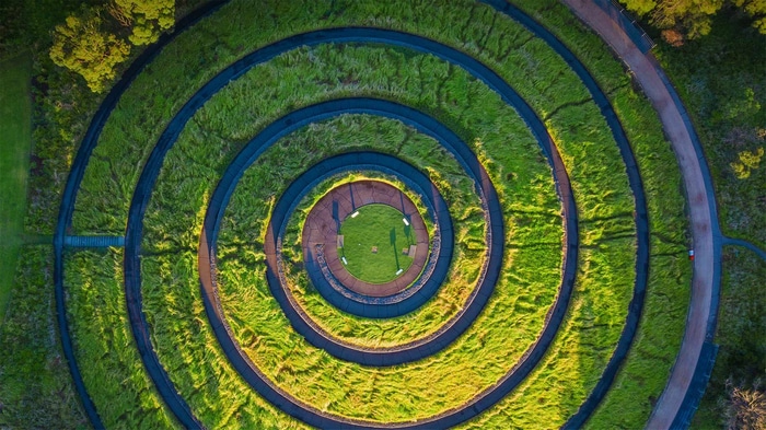 Aerial view of a spiral garden with grassy terraces