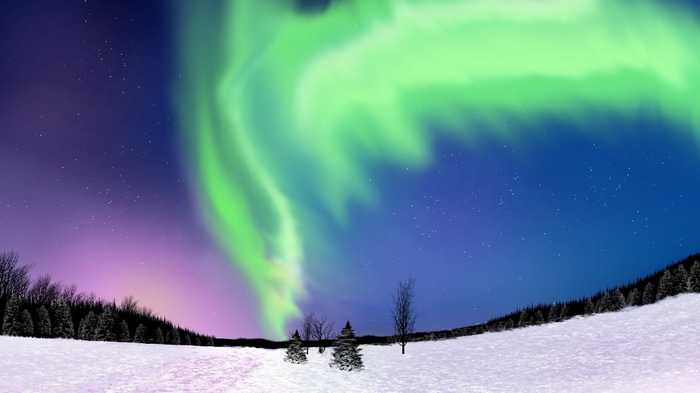 Aurora Borealis over a snowy landscape