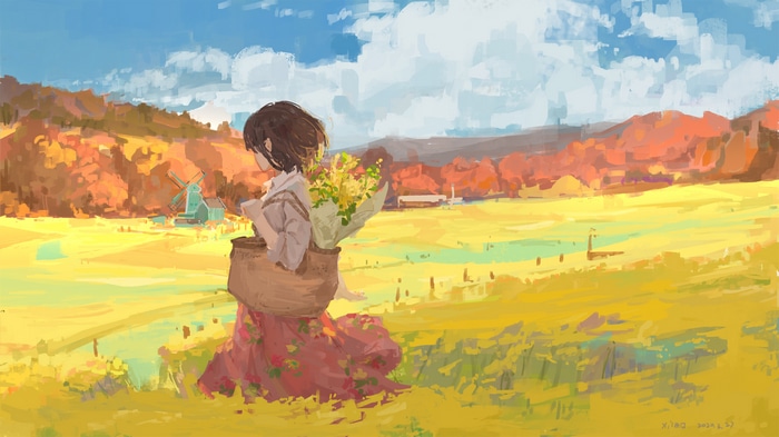 Girl with flowers in a field with a windmill
