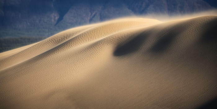 4K sand dunes with wind and mountains