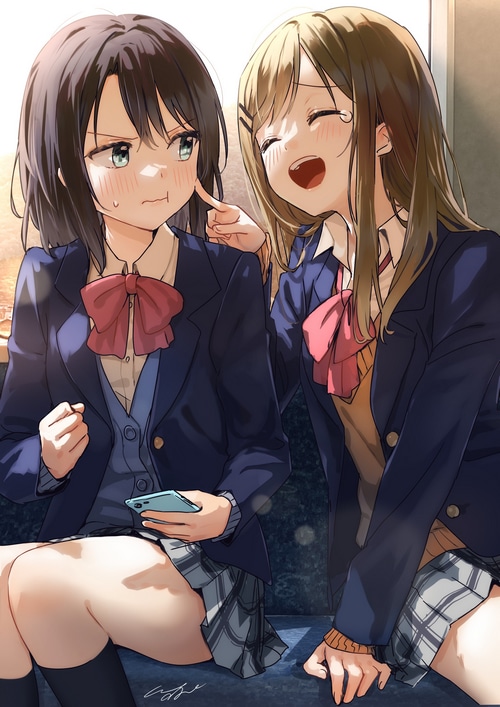 Two schoolgirls in uniform on a train
