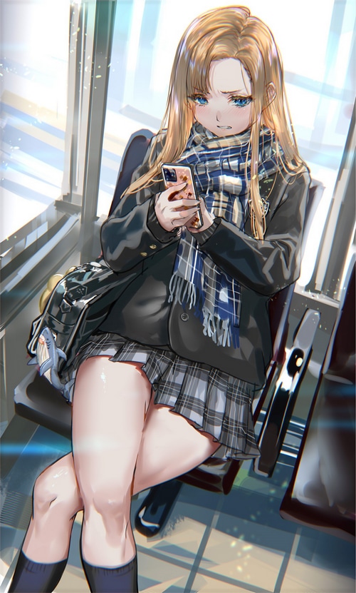 Schoolgirl in uniform looking at her phone