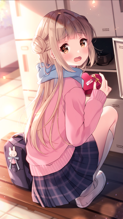Schoolgirl with blonde hair holding a heart-shaped box