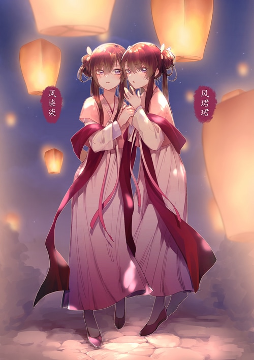 Twin girls in traditional Chinese clothing with lanterns