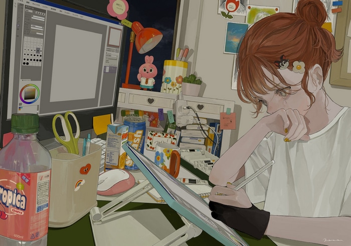 Girl crying while drawing on a tablet
