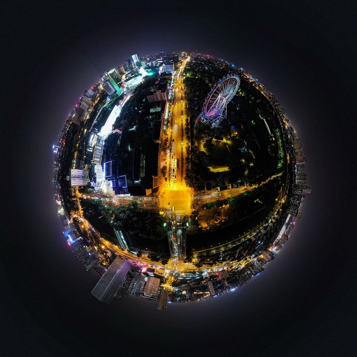 Night cityscape with a Ferris wheel and DJI Mavic drone view