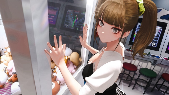 Girl playing claw machine at arcade